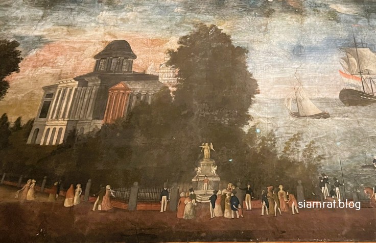 man standing under statue